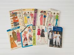 four different vintage sewing patterns on top of each other, one for women and one for men