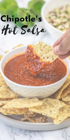 chipotle's hot salsa in a white bowl with tortilla chips