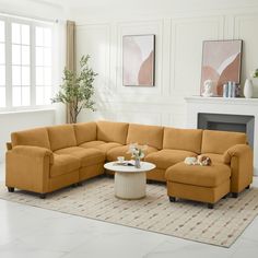 a living room with a sectional couch and coffee table in front of a fire place