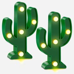 two green cactus shaped lights are shown in the shape of a light up cacti