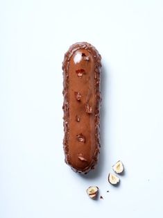 a piece of chocolate with nuts on the side and one half eaten hot dog bun