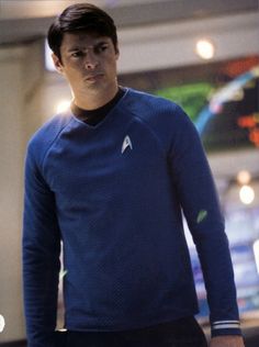 a man in a star trek uniform is standing