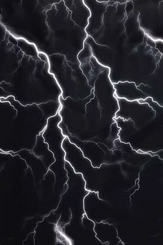 lightning strikes across the night sky in this black and white photo taken from an airplane