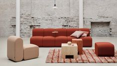 a living room filled with furniture and brick walls