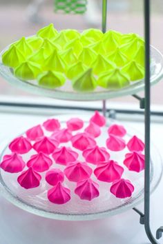 three tiered trays filled with different colored paper flowers