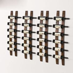 a wall mounted wine rack with several bottles on it's sides and two rows of empty wine bottles in the middle