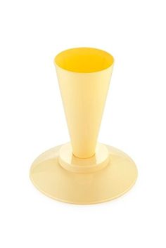 a yellow cup sitting on top of a white plate with a saucer underneath it