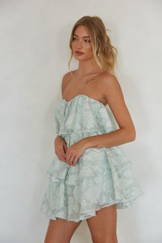 Make a romantic statement in the Masie Floral Sequin Strapless Babydoll Mini Dress! This stunning dress features a floral sequin embellished overlay, strapless sweetheart neckline, and a tiered ruffle skirt. Slip into an elegant heel to complete this unforgettable look! Details 100% Polyester Lining: 97% Polyester, 3% Spandex Fully lined Silicon grip Hidden back zipper with clasp closure Hand wash cold / Hang dry Sorority Formal Dress Short, Sorority Formal Dress, Black Graduation Dress, Semi Dresses, Sorority Rush, Babydoll Mini Dress, Rush Dresses, Tiered Ruffle Skirt, Formal Dresses Short