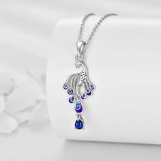 Adorn yourself with elegance with our sterling silver, white gold plated peacock pendant necklace. This stunning piece features a mesmerizing blue pearshaped crystal, making it the perfect addition to any womans jewelry collection.Crafted from premium sterling silver and enhanced with white gold plating, this exquisite pendant necklace showcases a dazzling pearshaped crystal in a vibrant blue hue, designed to resemble a graceful peacock. The intricate artistry and quality materials make it not o Peacock Pendant, Silver Necklaces Women, Crystal Necklace Pendant, Silver Pendant Necklace, Crystal Pendant, Sterling Earrings, Stones And Crystals, Sterling Silver Necklaces, Jewelry Sales