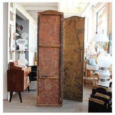 an old wooden cabinet is in the middle of a room with other furniture and decor