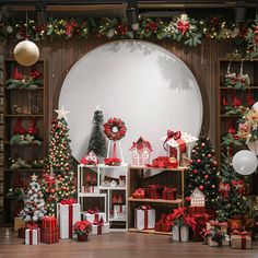 christmas decorations and presents on display in front of a round window