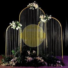 an elaborately decorated wedding arch with flowers and pearls on it's sides is shown