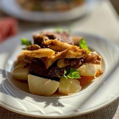 a white plate topped with food on top of a table