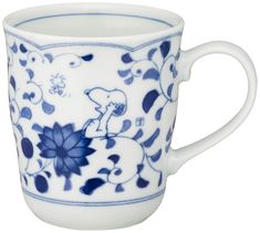 a blue and white coffee cup with an elephant on the side, in front of a white background