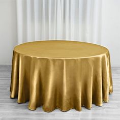 a round table with a gold cloth on it