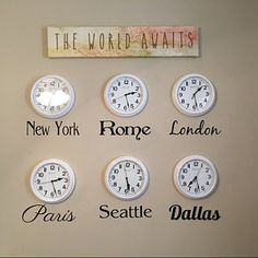 a wall with many clocks on it that say the world awaits, new york, rome, london, paris, seattle, and dallas