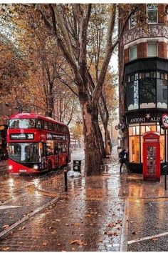 two red double decker buses parked next to each other on a street in london, united kingdom