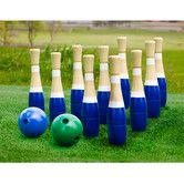 a group of bowling pins and balls in the grass