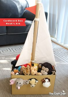 a toy boat filled with stuffed animals on top of a carpeted floor next to a couch