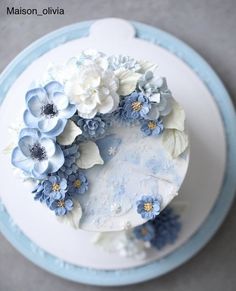 a cake with blue and white flowers on it