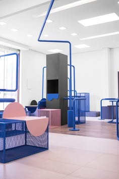 an empty room with blue and pink furniture