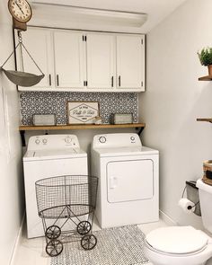 a white washer and dryer sitting next to each other in a laundry room