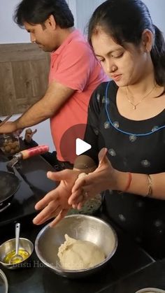 two people preparing food on top of a stove