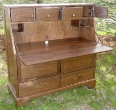 an old fashioned wooden desk in the grass