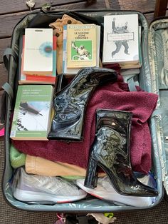 an open suitcase filled with books and other items