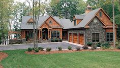 this is an image of a house in the country style with stone and wood accents