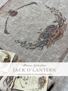 a close up of a piece of fabric with an image of flowers on it and the words jack o'lantern