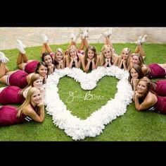 a group of women laying on top of each other in front of a heart shaped photo