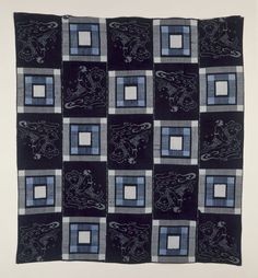 a black and white quilt with squares on the bottom, one square has an image of a