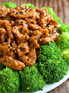 broccoli and chicken on a plate with sesame seeds