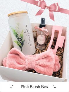 the pink blush box is filled with personal care items and has a bow tie on it