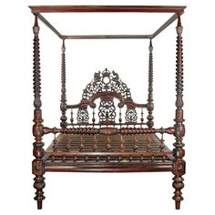 an antique wooden bed frame with intricate carvings