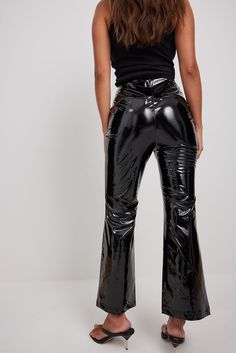 These pants feature a flared leg, a side zipper closure and a high waist fit. Latex Bell Bottom Pants, Bell Bottoms Leather Pants, Latex Flare Pants, Black Pvc Pants, Luxury Chic Flared Leather Pants, Luxury Fitted Shiny Pants, Vinyl Straight Leg Pants, Vinyl Black Pants, Latex Wide Leg Pants