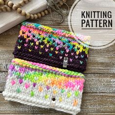 two knitted bags sitting on top of a wooden table next to beaded beads