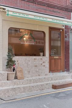 a brick building with two planters and a door on the outside, in front of it