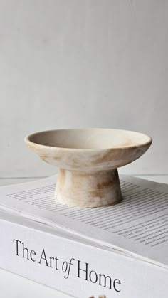 a bowl sitting on top of a book