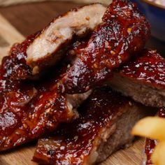 barbecue ribs and french fries on a cutting board