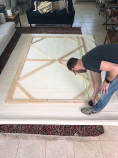 a man measuring the length of a mattress