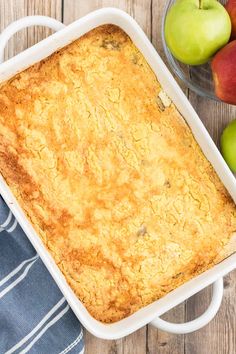 a casserole dish with apples in the background