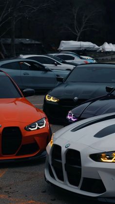 several different colored cars parked in a parking lot