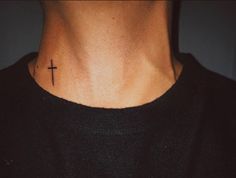 a man with a cross tattoo on his neck