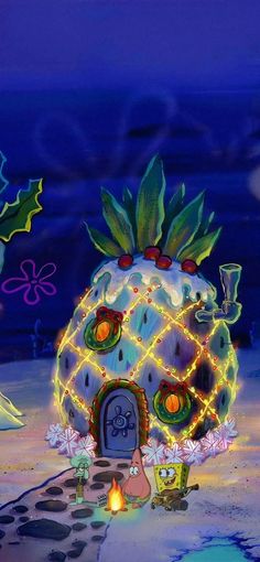 an animated image of a pineapple house with christmas lights and decorations on the ground