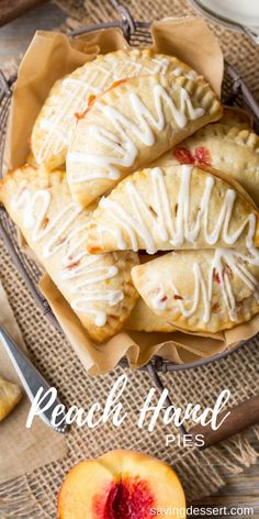 peach hand pies with icing on top and sliced peaches in the background