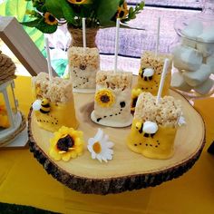 the desserts are made to look like sheep and bees on sticks with daisies