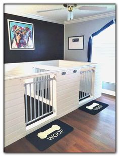 a white dog gate in the corner of a room with hardwood floors and black walls