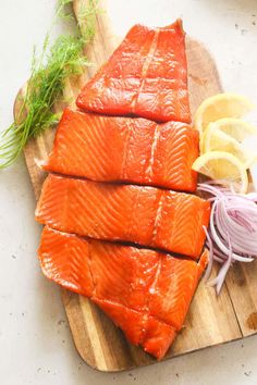 some salmon and onions on a cutting board